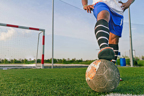 istock Old ball football on grass 485510508