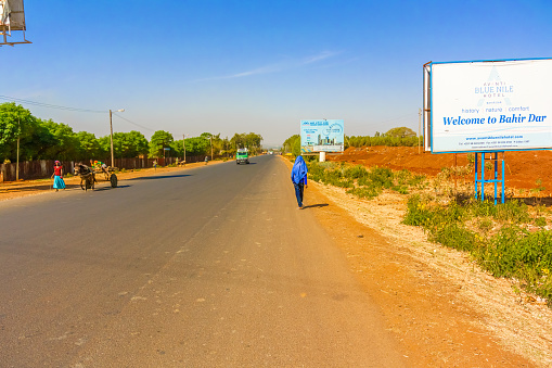  Bahir Dar - February 11, 2015: Person is walking by the Welcome sign to Bahir Dar . It is town in Ethiopia.