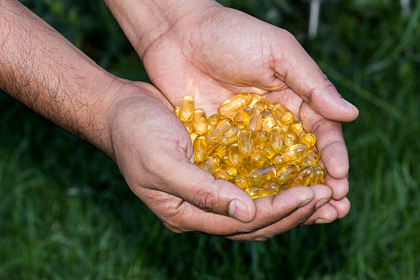 istock Vitamin Omega-3 fish oil capsules on a hand 485512270