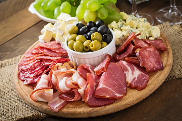 istock Antipasto catering platter with bacon, jerky, salami, cheese and grapes 485516292