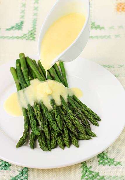 Unrecognizable woman eating healthy asparagus