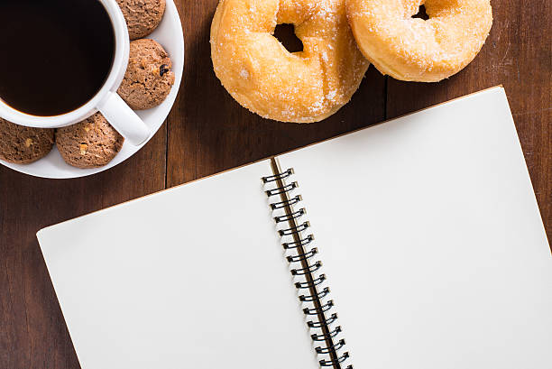 istock Recipe notebook, donuts, Coffee cup, cookie on wooden background 485517186
