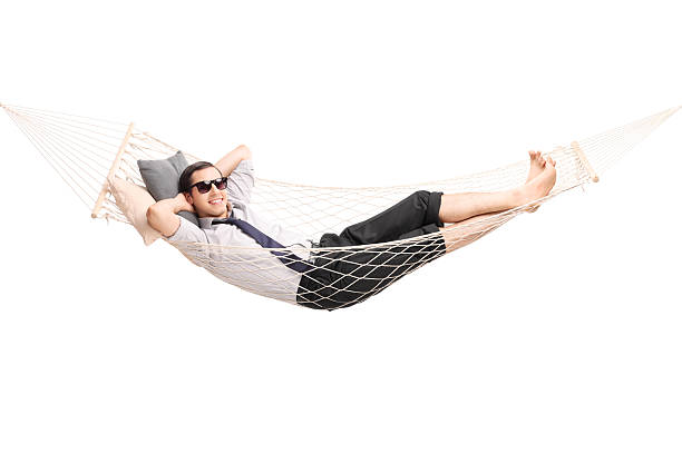 istock Carefree young businessman lying in a hammock 485518468