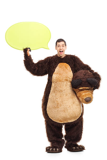 istock Young man in bear costume holding a speech bubble 485518490