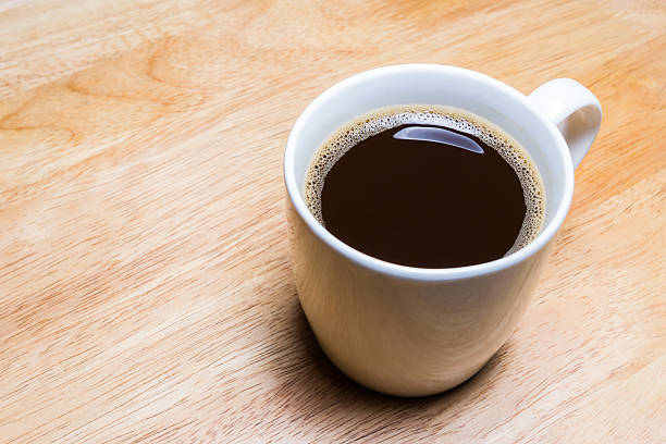 istock Cup of coffee on wooden table. 485518802