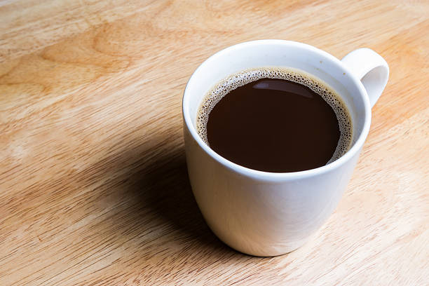 istock Cup of coffee on wooden table. 485518804
