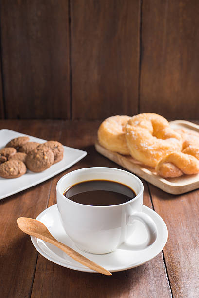 istock Coffee cup, donuts, cookie on wooden background 485523182