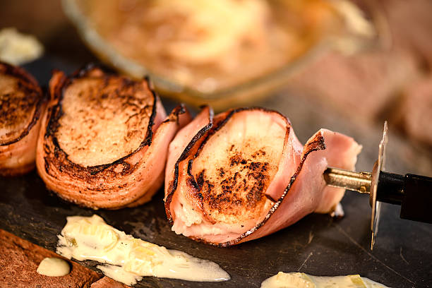 istock Skewer of grilled scallops wrapped in ham 485523218