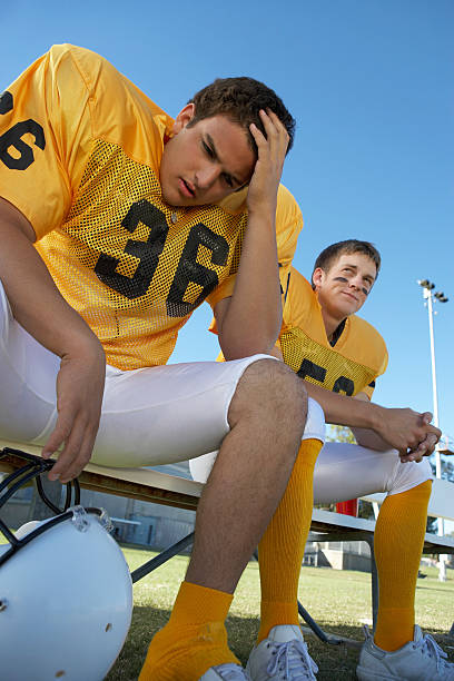 istock Two Football Players on the Bench 485524721