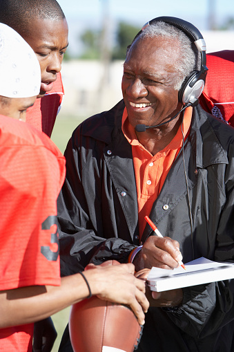 Football Coach Talking to Two Players