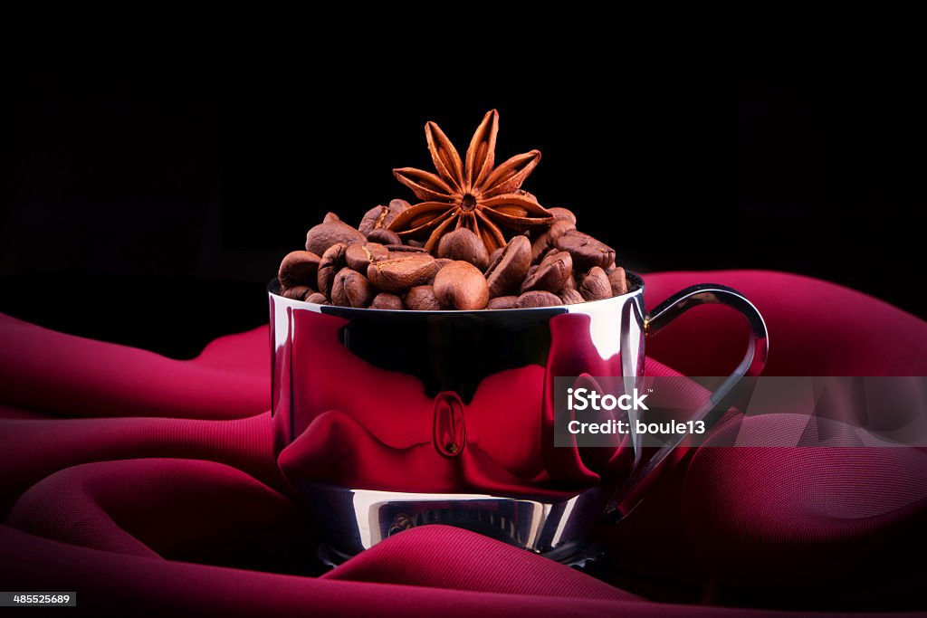 cup of Coffee with beans on red silk cup of Coffee  with beans on red silk. Vintage background Brown Stock Photo