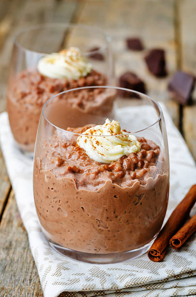 istock chocolate rice pudding decorated with whipped cream with cinnamon 485525756