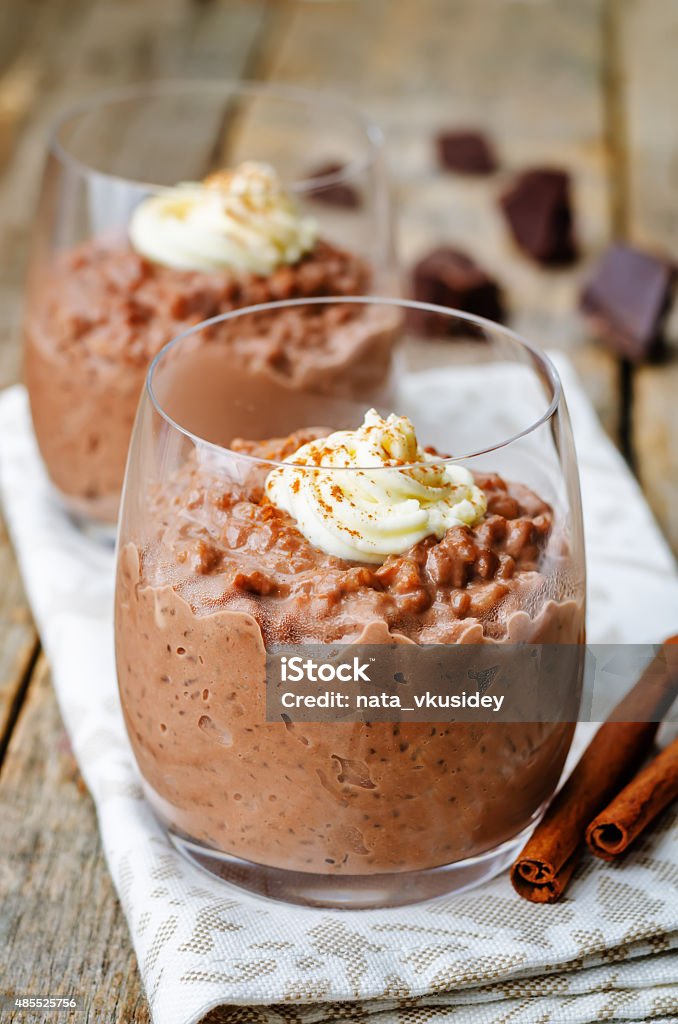 chocolate rice pudding decorated with whipped cream with cinnamon chocolate rice pudding decorated with whipped cream with cinnamon. the toning. selective focus 2015 Stock Photo