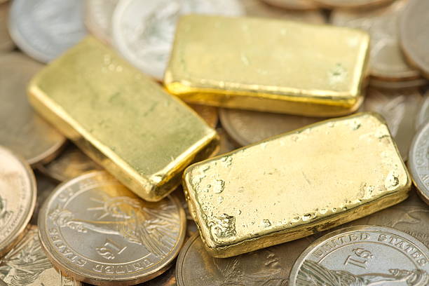 istock Gold bar over dollar coins 485526692