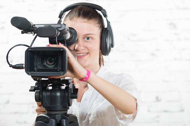 istock pretty young woman with a professional camera 485527452