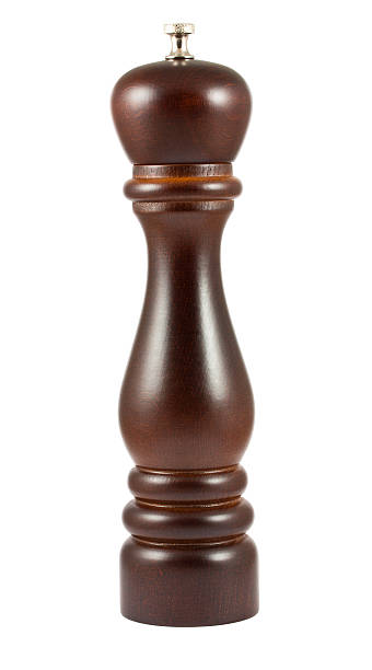 Dark brown pepper mill Dark brown pepper mill isolated on white background pepper shaker stock pictures, royalty-free photos & images