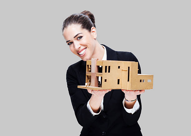 istock Female business agent holding house model 485527646