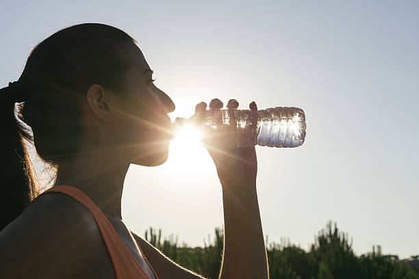 istock Backlighting of a runner woman drinking water 485530140