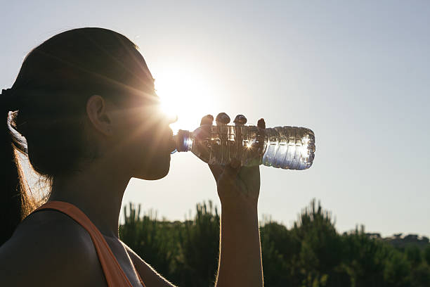 istock Backlighting of a runner woman drinking water 485530144