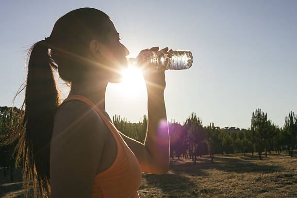 istock Backlighting of a runner woman drinking water 485530146