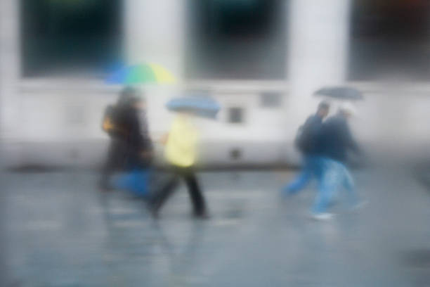 istock Rainy day Shoppers with umbrellas 485531156