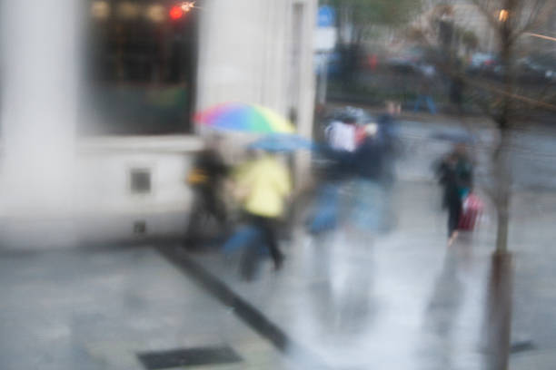 istock Looking down on Rainy Day shoppers umbrellas. 485532132