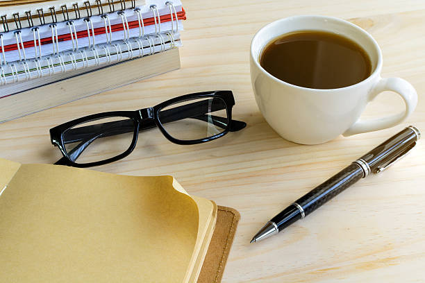 istock Cup of coffee with blank notebook on wooden desk 485535596
