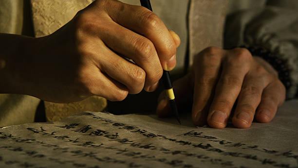 istock Person writing Japanese calligraphy in traditional style 485536002