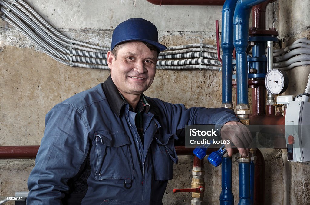 Plumber in the basement 2015 Stock Photo