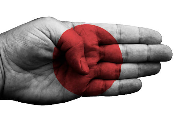 istock Hand embellished with the flag of Japan on white 485537863