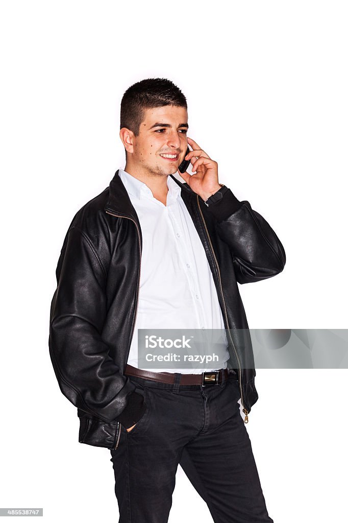 Young man talking business on cell phone Smiling young man is talking business on cell phone - isolated on white Adult Stock Photo