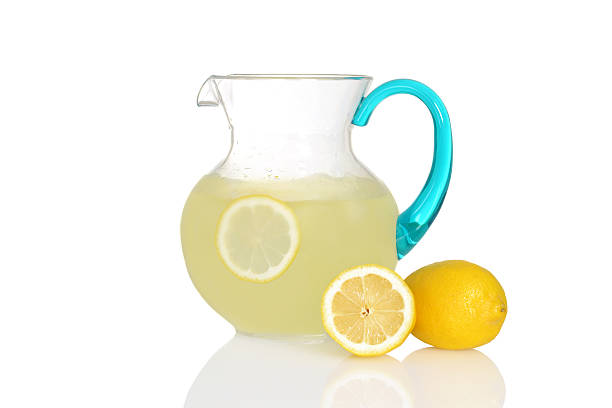 pitcher of lemonade with fresh lemons with white background 