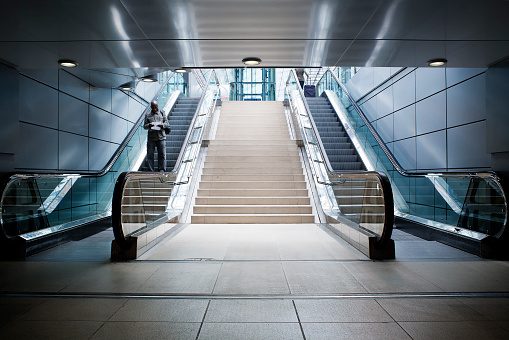 Frankfurt, Germany - July 3, 2011: A middle-aged male passenger on its way to the train station platform at Frankfurt Airport railway station. Frankfurt Airport long distance railway station connects Frankfurt International Airport to trains on the Cologne-Frankfurt high-speed rail line.