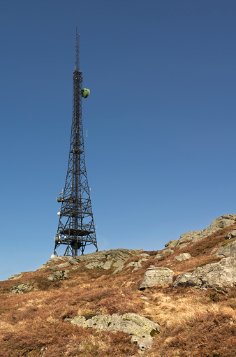 Rundemanen is one of seven mountains surrounding the City of Bergen (in Norway). Bergen Radio started broadcasting from this location in 1912. The current radio tower (or mast) is from 1990 and is 106 meters tall.