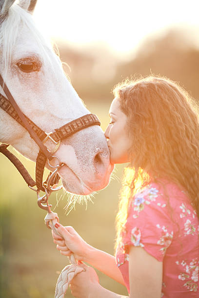 istock Young woman and white horse 485541501
