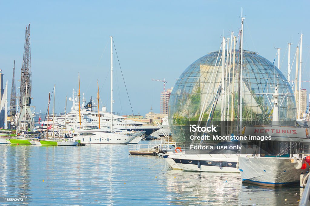 Old Port in Liguria, Italy Genoa, Italy - September 7, 2013: A view across Porto Antico with several boats visible, including named ones, and the Biosphere of Genoa Aquarium.  Capital Cities Stock Photo