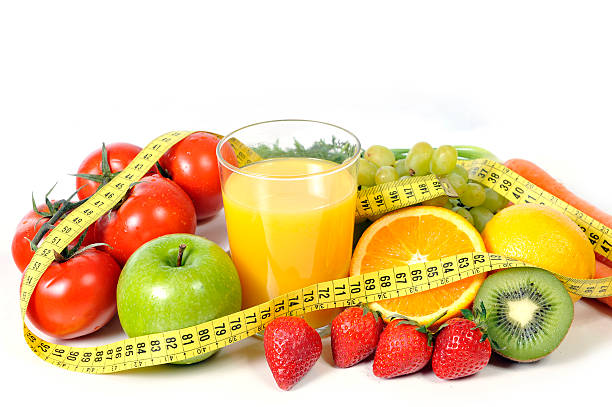 istock fresh fruit , vegetables and orange juice wrapped in measure tape 485543677