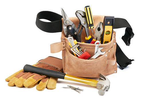 variety of tools with tool belt on white background