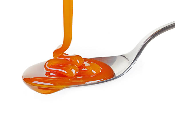 istock spoon of caramel sauce 485546122