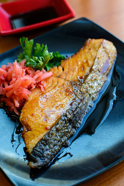 istock Salmon steak and ginger preserves in  black dish 485549928