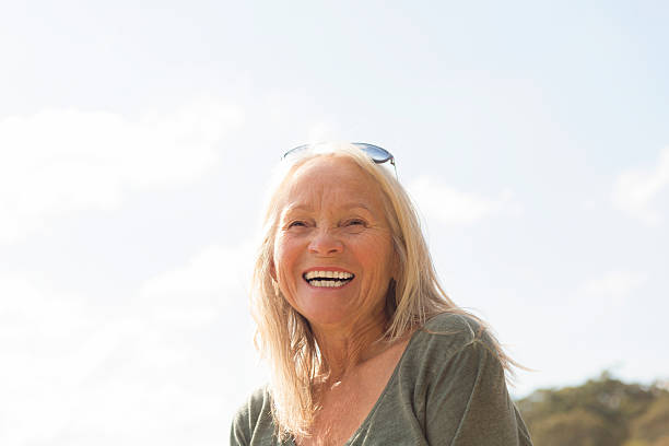 istock Beautiful mature woman smiling, copy space 485553458