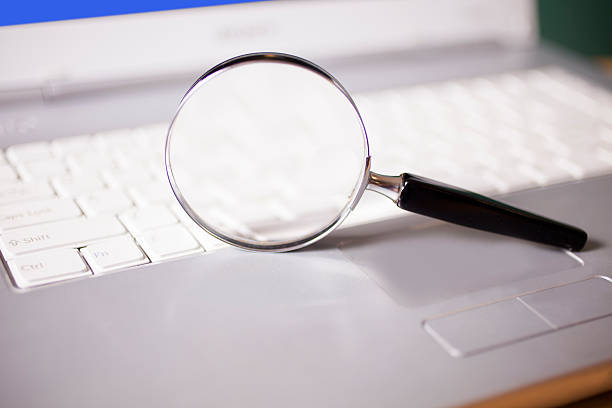 istock Business concepts. Round magnifying glass on laptop computer keyboard. 485555386