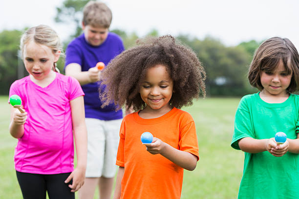 istock Multiracial group of children in an egg spoon race 485555760