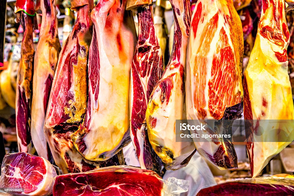 Pieces of prosciutto or cured ham on butcher's market  display. Backgrounds Stock Photo