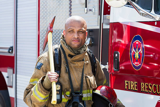 istock African American fire fighter carrying axe 485557808
