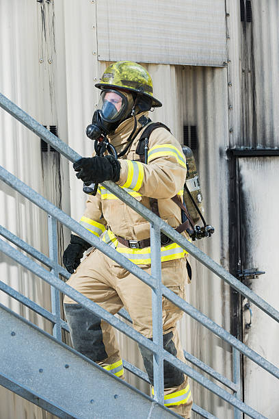 istock Fireman in protective suit, oxygen mask climbing stairs 485557820