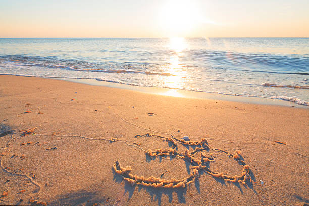 istock Om symbol in the sand by the ocean 485558504