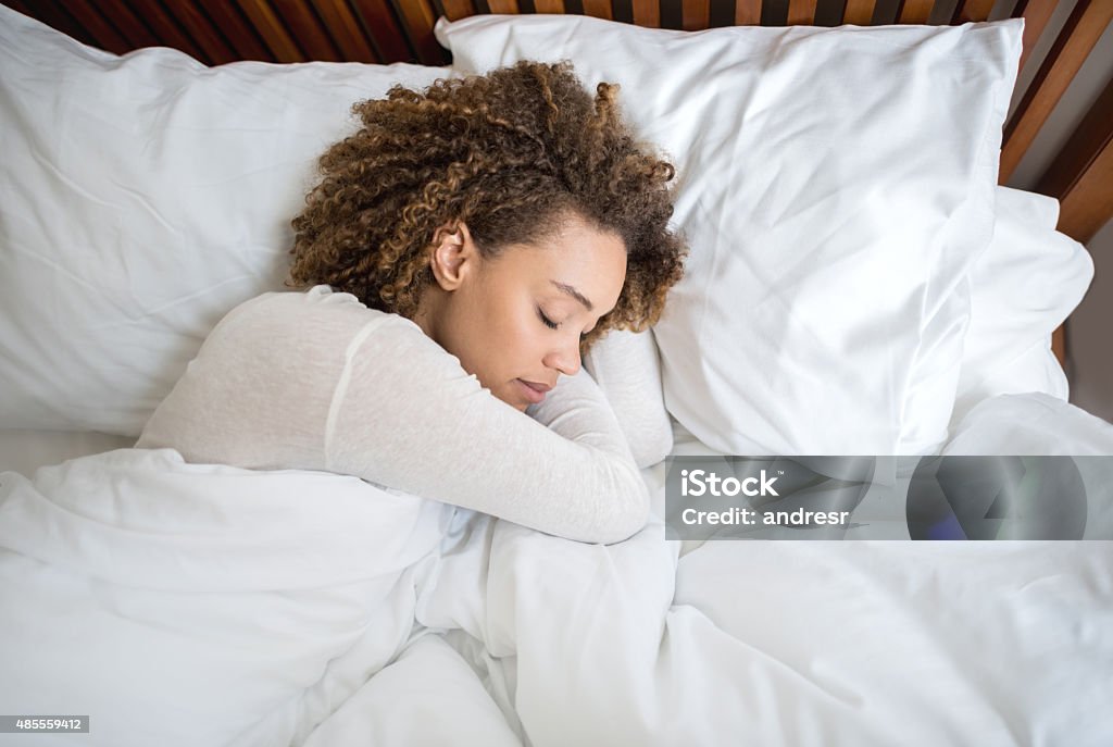 African American woman sleeping in bed Tired African American woman sleeping in bed at home Sleeping Stock Photo