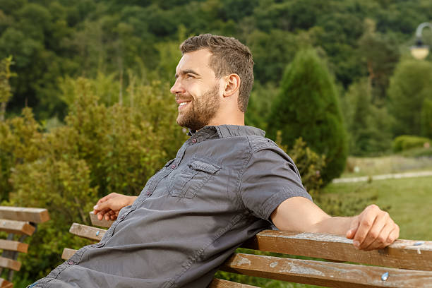 istock Man sits on the bench and relax in public park 485559702