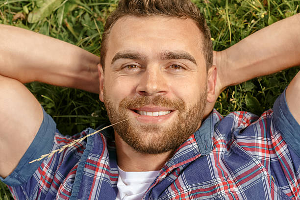 istock Handsome man lying on the grass in park 485562926